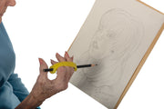 Adult uses three fingers in a universal cuff to draw a picture.
