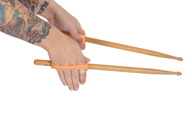 Hands gripping drumsticks that have been modified with easyhold silicone universal cuffs 
