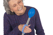 Woman with arthritis hold kitchen implement adapted with a blue eazyhold grip assist